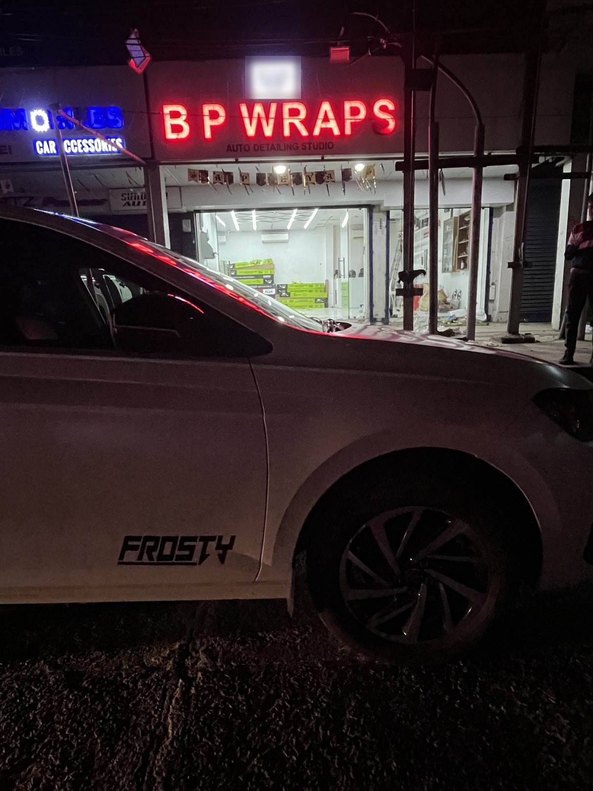 BP Wraps auto detailing studio storefront at night
